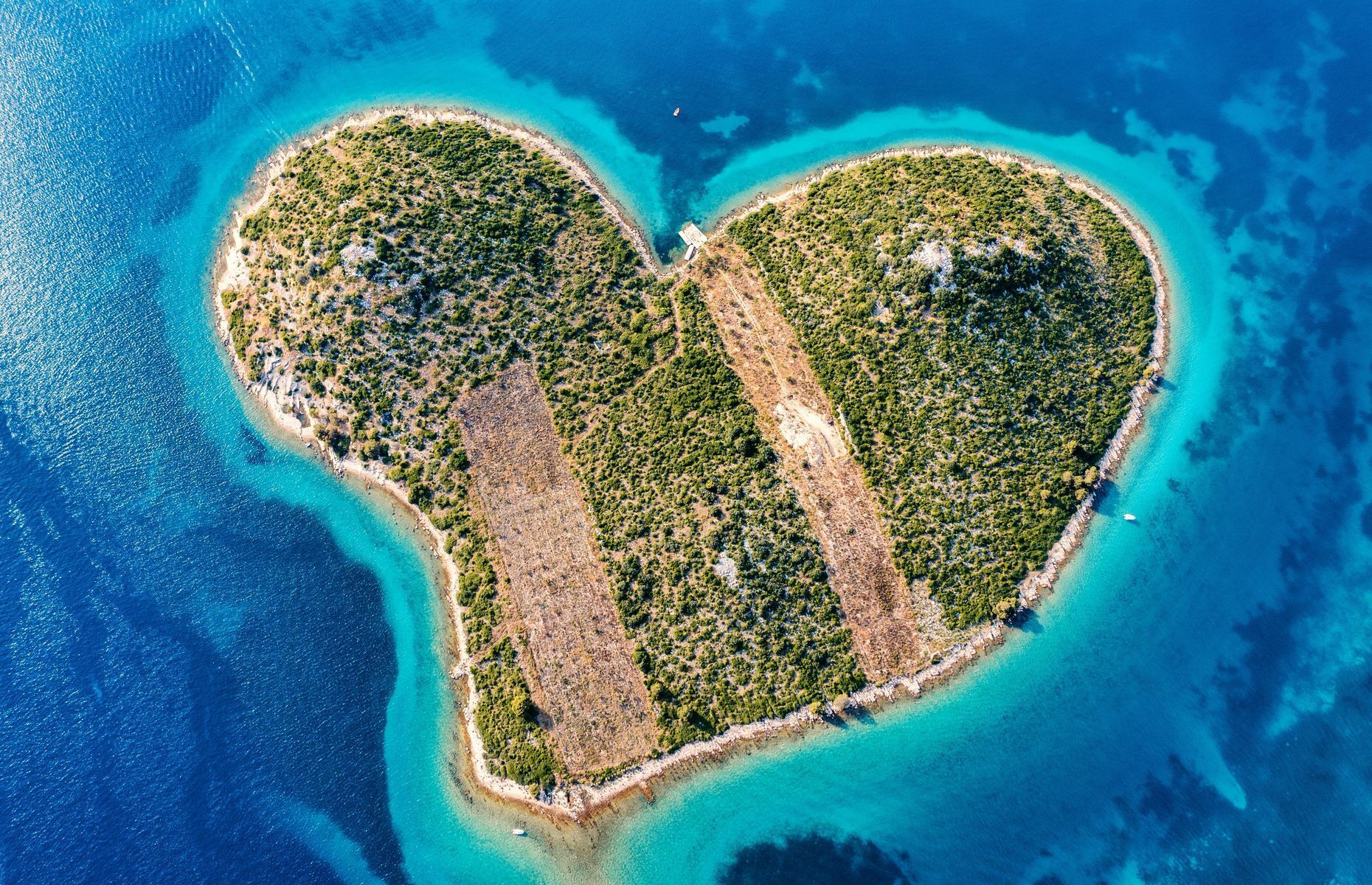 Famous for being shaped like a heart, the island of <a href="https://mybestplace.com/en/article/galesnjak-the-heart-shaped-croatian-island" rel="noreferrer noopener">Galešnjak</a> lies in the Adriatic Sea’s Pašman Channel not far from the village of Turanj. Also nicknamed “Love Island,” this enchanting spot is ideal for romantic strolls along secluded beaches kissed by turquoise waters. Numerous boat excursions are available to take you from Zadar to this uninhabited natural paradise.