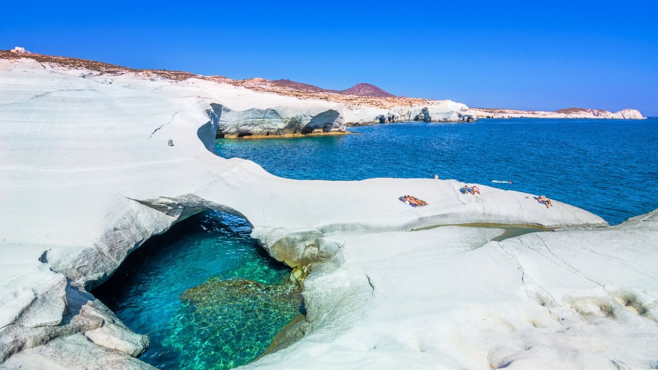 <p><span>Experience the otherworldly charm of Sarakiniko Beach on the island of Milos, Greece. Its lunar-like landscape, sculpted by wind and waves, creates a unique setting for beach lovers to explore. </span></p>