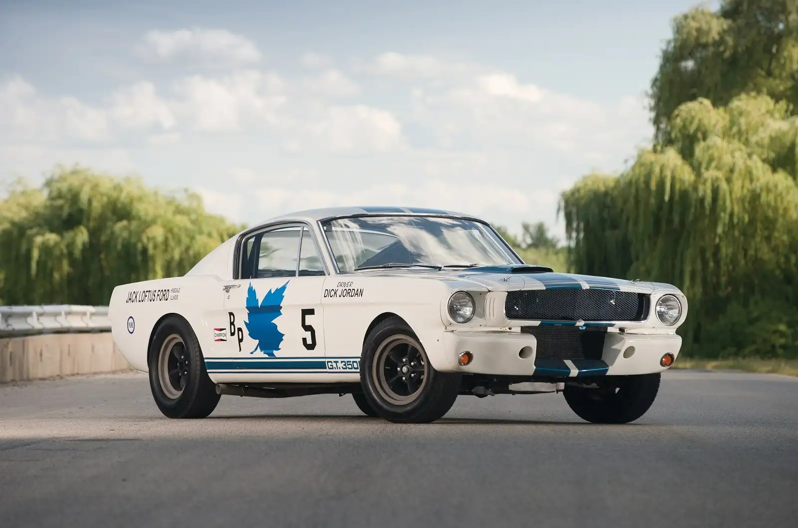 <p>In 1965, Carroll Shelby collaborated with Ford to build a purpose-built race car, reworking a Mustang into the GT350R. Its lightweight, stripped-down design included a fiberglass front apron, wide fender flares, adjusted suspension pickup points, a large 4-point roll cage, and a reworked engine yielding 325 to 360 horsepower.</p><p>The Shelby GT350R had a historic 17-race winning streak from 1968-1969, and reached a record speed of 184 mph at Daytona. The GT350R is forever emblazoned in our minds with its iconic white body and blue stripes.</p>