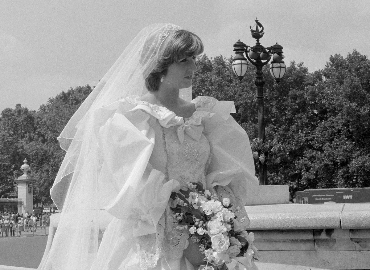 <p>If you think that's Princess Diana, look again. And again. And maybe again. While the bride in the snap looks identical to the real royal, she's <em>actually</em> a lookalike posing for a TV segment. Talk about a doppelgänger!</p>