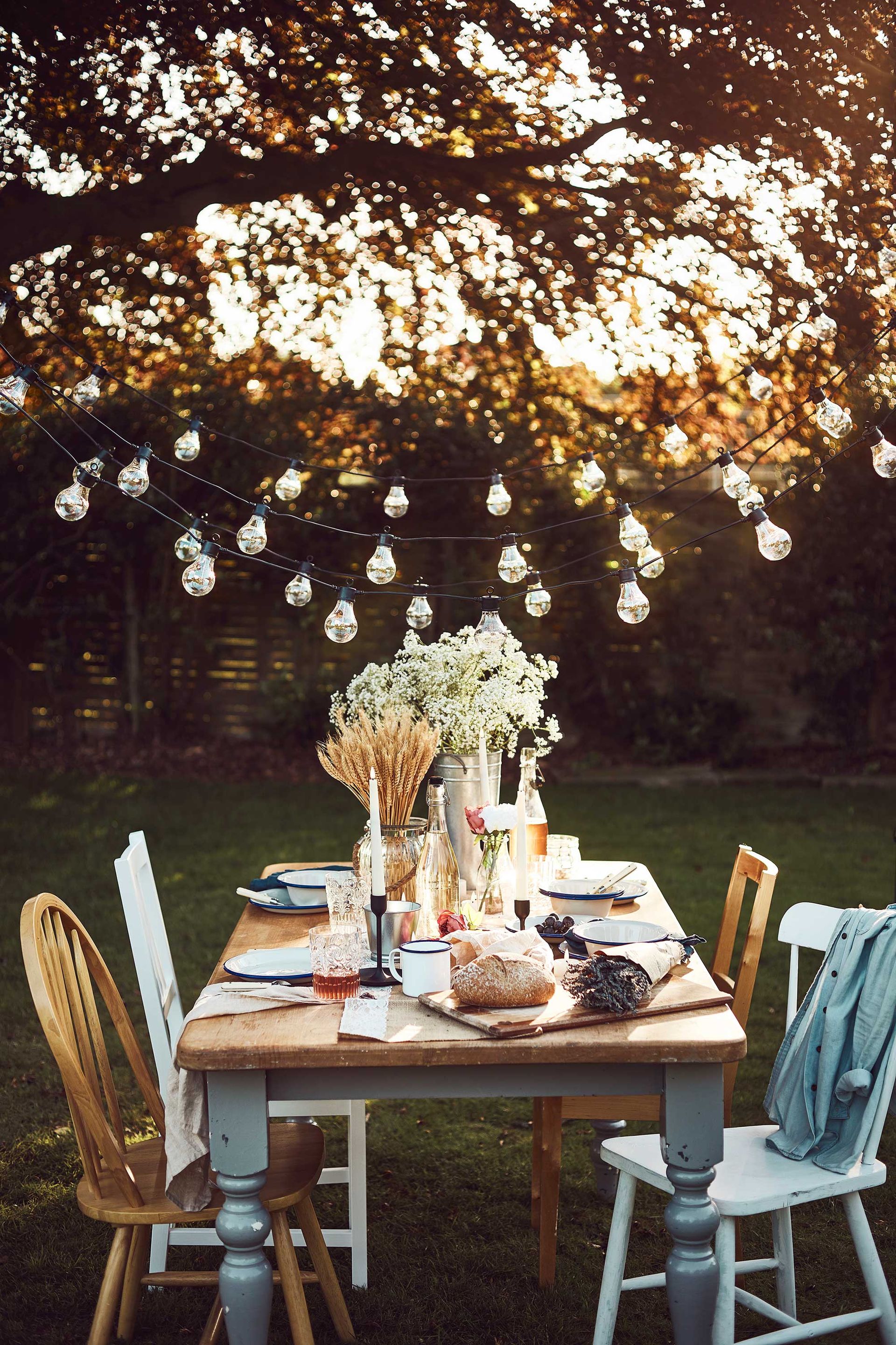 <p>                     If your outdoor table is a little small for large-scale entertaining, then don't be afraid to put your indoor table and chairs to good use. Bringing them out onto the lawn or patio just for the day will instantly give your backyard a refreshed look and make it feel more special.                   </p>                                      <p>                     String up festoons overhead from nearby trees or fences for an atmospheric glow once the sun begins to set. A jumble of different sized vases filled with both fresh and dried flowers and foliage; wooden boards; mix and match table linens and cut glass tumblers will form an eclectic and relaxing vibe. Add blankets and cushions too, to keep everyone toasty should a breeze pick up.                   </p>