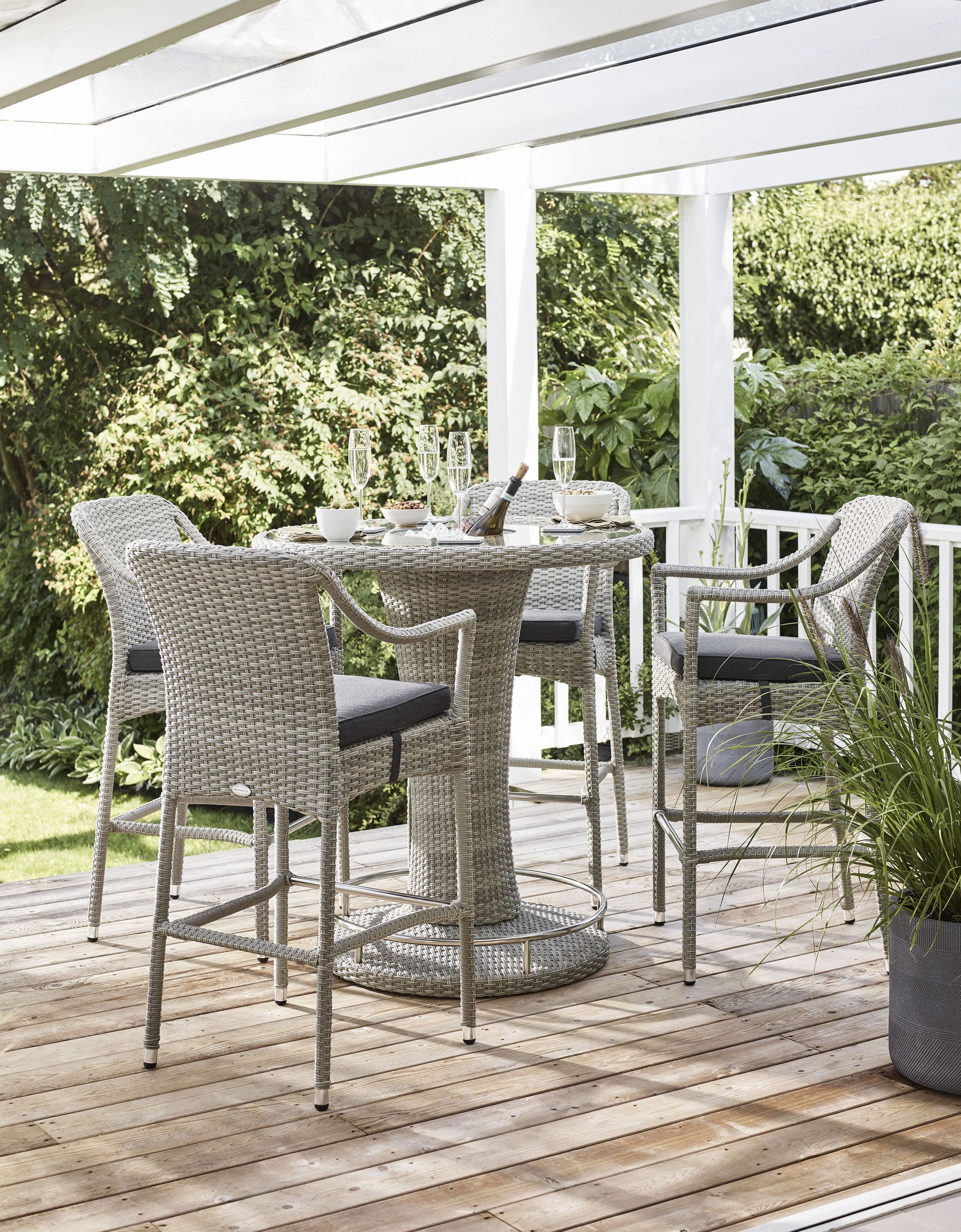 <p>                     Singapore Sling anyone? Bring a touch of Raffles-style glamour to your patio ideas with a stylish plantation-style wicker bar set. That way, you can truly relax over chilled pre-dinner drinks as it will feel like being on holiday.                   </p>                                      <p>                     This set above is made of maintenance-free wicker and comes with four bar stools and a table. Plus, it has a removable ice bucket in the center for keeping your bottle of bubbly within arm's reach.                   </p>