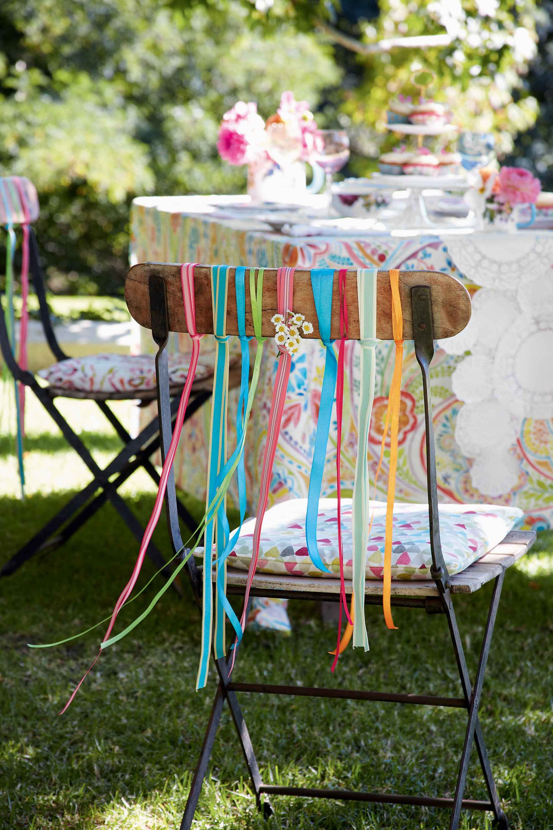 <p>                     If you're looking for garden party ideas on a budget, then how about this pretty look? It's ideal for giving a lift to foldaway chairs and is oh-so-simple to recreate.                   </p>                                      <p>                     All you need is a handful of brightly colored ribbons to add to your outdoor seating. They will look gorgeous as they flutter in the breeze and will add an instant summery feel to any space. Finish the look with tie-on cushions for an extra dose of vibrancy and to up the comfy factor.                   </p>