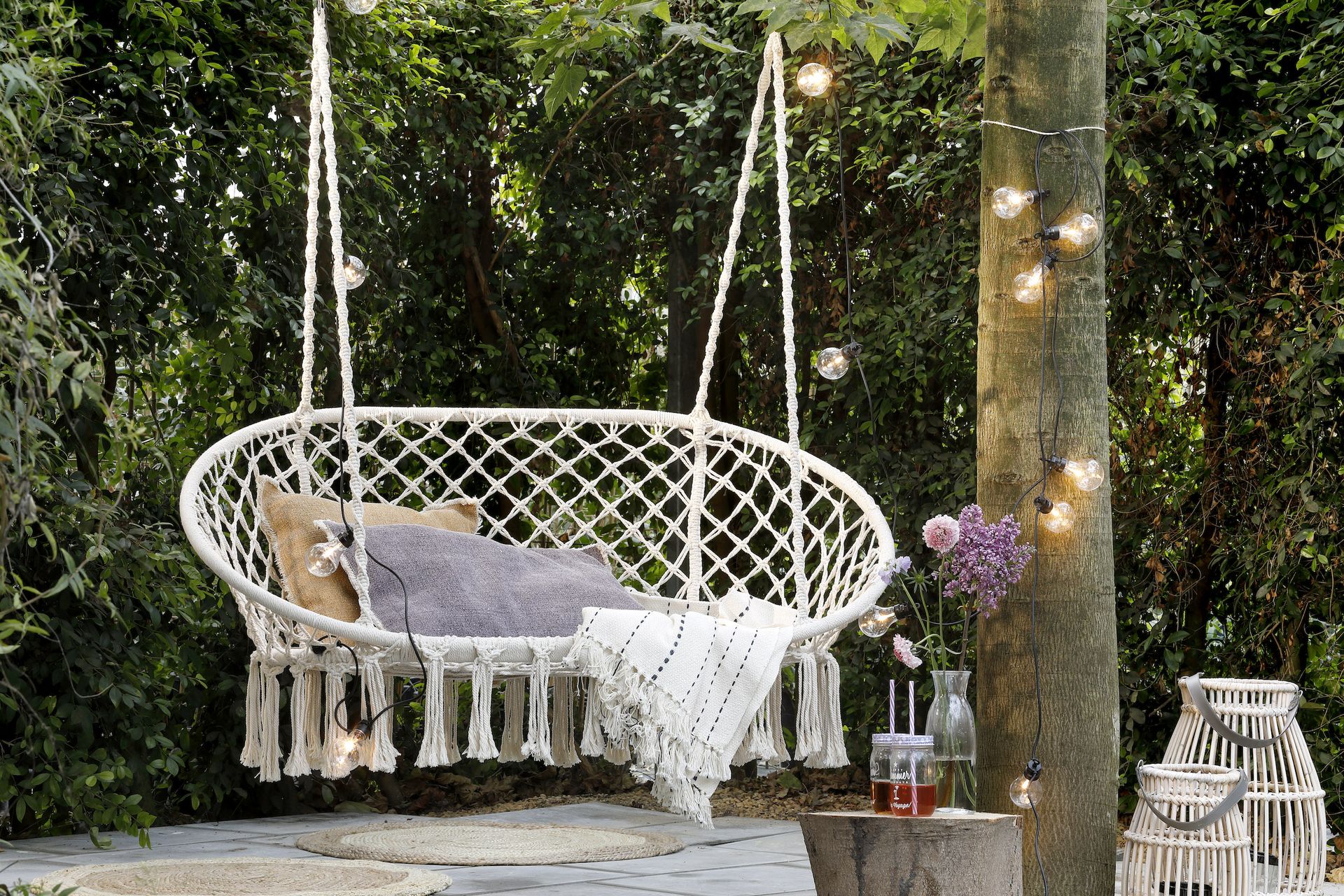 <p>                     Perfect for parties, garden swing seats is just the thing for catching up with a friend over a glass of something chilled. This one is made of on-trend macramé and we love the tassel trim, which adds just the right touch of boho.                   </p>                                      <p>                     Style it up with some cushions and a throw in case it gets chilly later.                   </p>