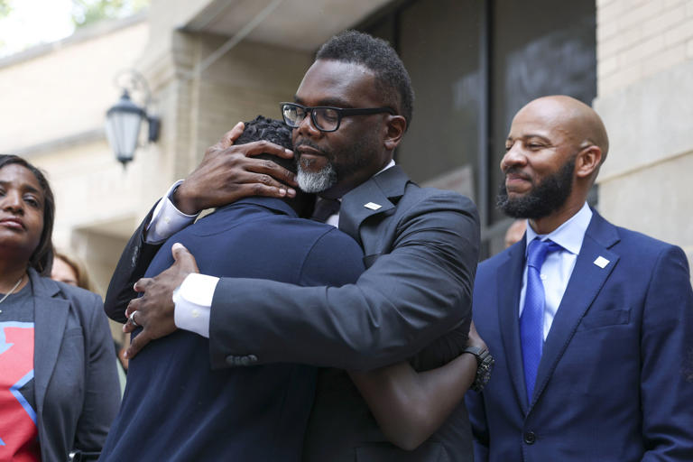 Mayor Brandon Johnson hugs Chicago Public Schools student Mouhamed Mbengue at Kenwood Academy High School on the first day of school on Aug. 21, 2023.