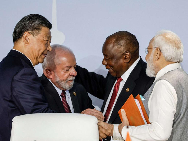 President of China Xi Jinping, President of Brazil Luiz Inacio Lula da Silva, South African President Cyril Ramaphosa and Prime Minister of India Narendra Modi gesture during the 2023 BRICS Summit in Johannesburg on August 24, 2023.