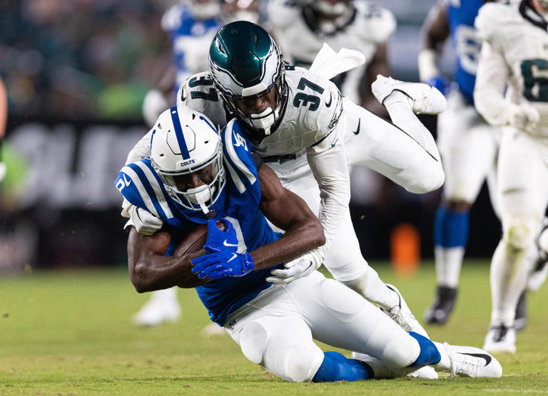 Philadelphia Eagles cornerback Kelee Ringo (37) tackles Indianapolis Colts wide receiver Breshad Perriman (9) after his catch during the third quarter at Lincoln Financial Field on Aug 24, 2023, in Philadelphia.