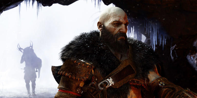 Kratos in cave with the silhouette of someone carrying a deer carcass in the cave's mouth behind him.. 