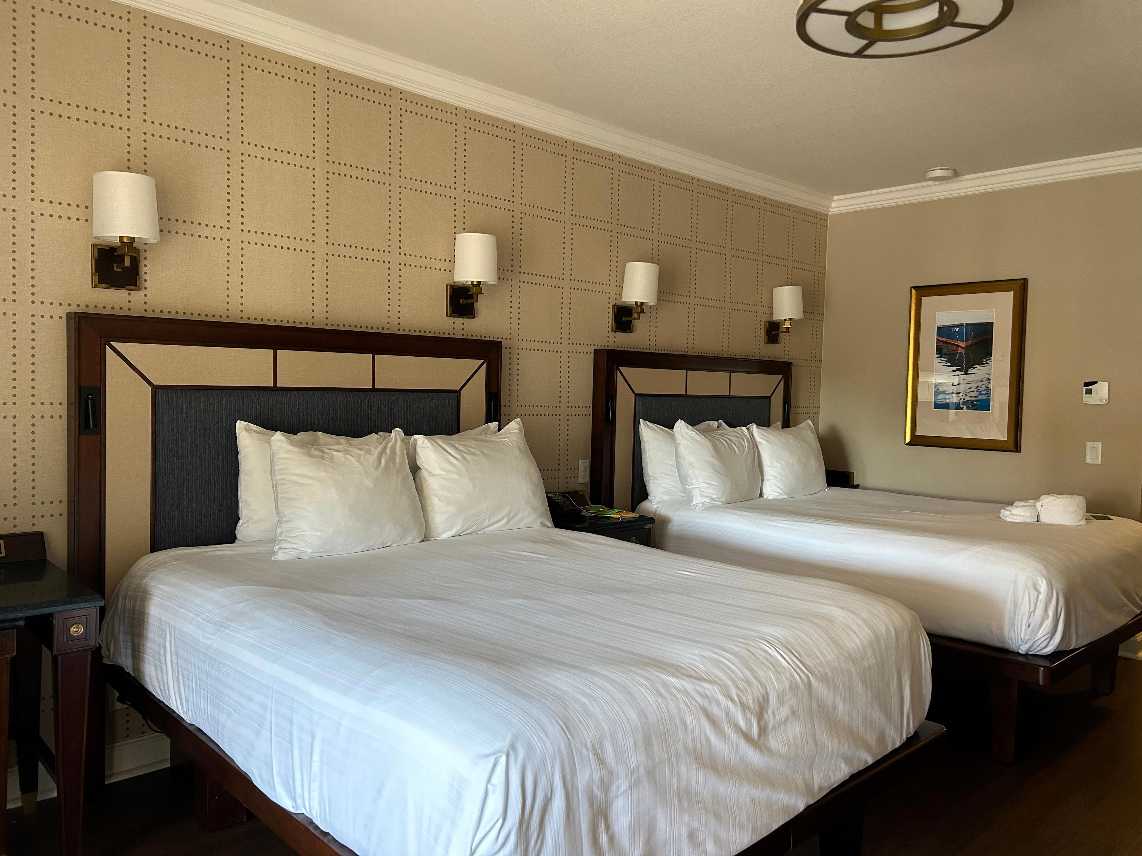 <p>Rooms at the Yacht Club start at $484 per night for a standard view and can go well into the thousands for suites and club-level accommodations, depending on the time of the year. </p><p>My room had two queen-sized beds, a balcony, and a view of the front gate of the resort. The room was equipped with a pull-out couch, mini fridge, a safe, Keurig coffee machine, and ample storage space for clothes and luggage underneath the beds.</p>