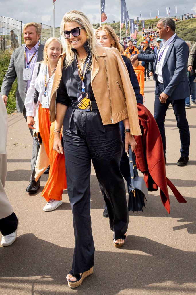 <p>Maxima was chicly on theme in a black cotton <a href="https://us.maxmara.com/p-6241023106004-valvola-black">jumpsuit by Max Mara</a> at the Dutch Grand Prix F1 race in Zandvoort. She paired the style with a camel <a href="https://go.redirectingat.com?id=74968X1553576&url=https%3A%2F%2Fwww.massimodutti.com%2Fus%2Fnappa-leather-biker-jacket-with-polished-edges-l04723636&sref=https%3A%2F%2Fwww.townandcountrymag.com%2Fsociety%2Ftradition%2Fg44714749%2Fqueen-maxima-netherlands-fashion-style-photos%2F">Massimo Dutti napa leather jacket</a>, Jimmy Choo sandals, and a Mari <a href="https://www.townandcountrymag.com/style/fashion-trends/g44774782/best-designer-crossbody-bags/">crossbody bag</a>. </p>