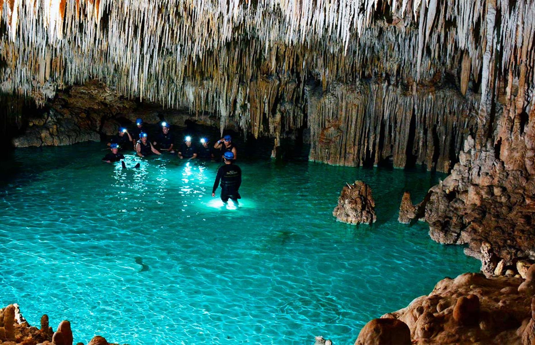 <p>Wade through turquoise rivers and wonder at the dramatic stalactites and stalagmites overhead in this ancient network of caves. Rio Secreto, meaning secret river, at Playa del Carmen was discovered in 2005 by a farmer who moved some rocks while chasing an iguana. It has since become a popular and highly-rated attraction among visitors. You don’t need to be a strong swimmer to take part and guests are issued with wetsuits and hard hats.</p>