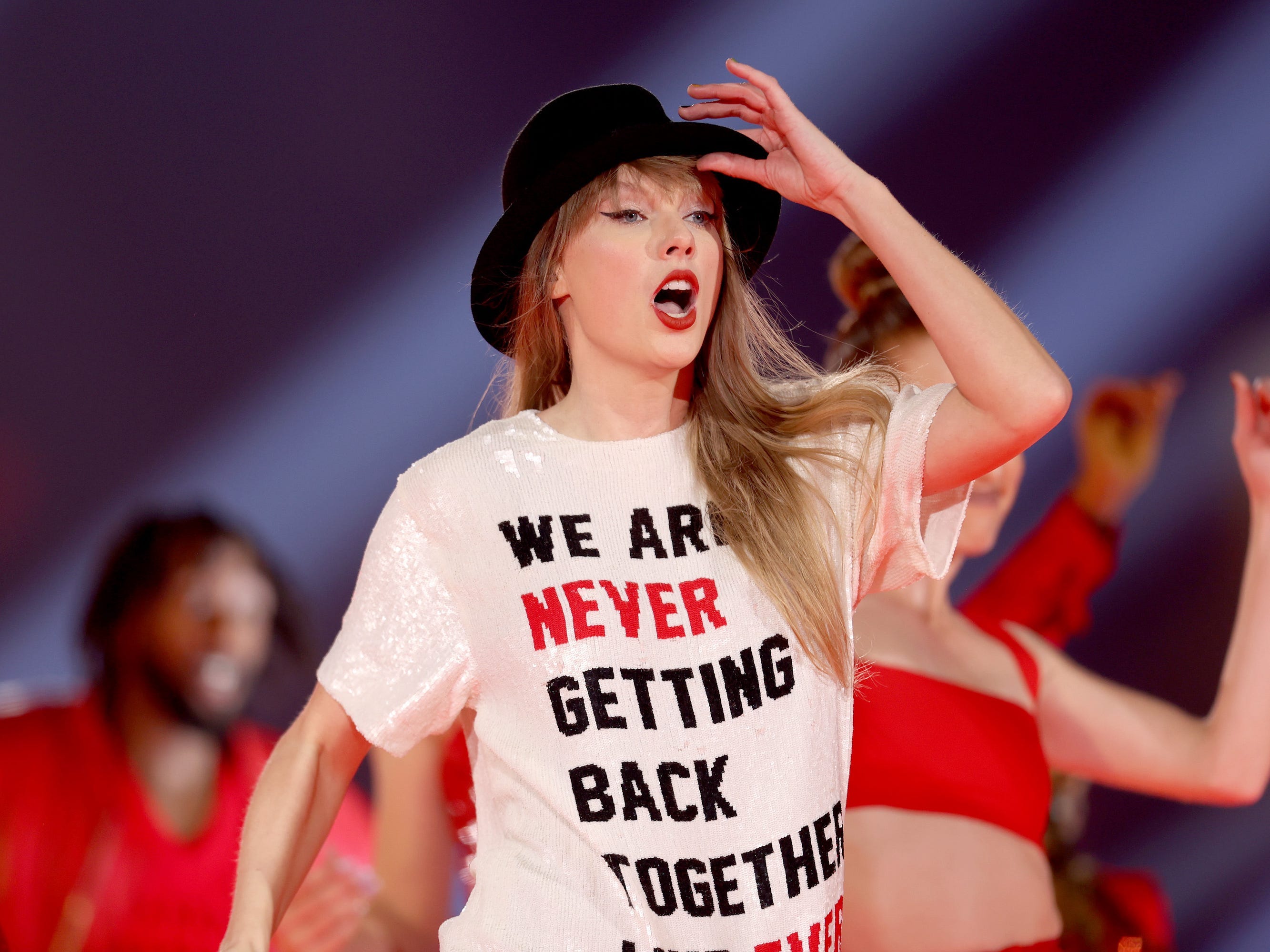 <p>There are three versions of this shirt, inspired by an outfit worn by Swift in the "22" music video: "A lot going on at the moment," "We are never getting back together like ever," and "Who's Taylor Swift anyway? Ew." The shirt is always paired with a black bowler hat.</p><p>The shirt isn't exactly high-fashion, but it gets extra points for the nostalgia factor. The hat is ugly, but it gets even more extra points for the cuteness factor, since Swift always gives it to <a href="https://www.insider.com/taylor-swift-kobe-bryant-daughter-bianka-hug-eras-tour-2023-8">a special fan in the crowd</a>.</p>