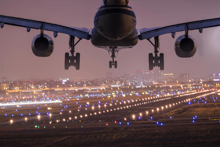 Airplane landing the shanghai airport in the night