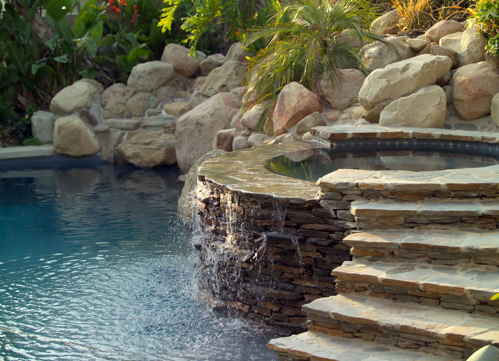 <p>                     Get the best of both worlds by combining pool ideas and hot tub ideas. Using a curve of stone steps and a relaxing spillover blends them together beautifully, while still creating an air of different zones.                   </p>                                      <p>                     It also makes it easy to go from one to the other, for a refreshing (or warming) boost.                   </p>