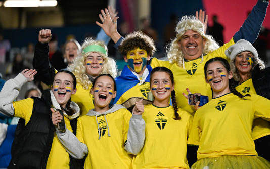 Swedish fans pose for a photo ahead of the Women's World Cup semifinal soccer match between Sweden and Spain at Eden Park in Auckland, New Zealand, Tuesday