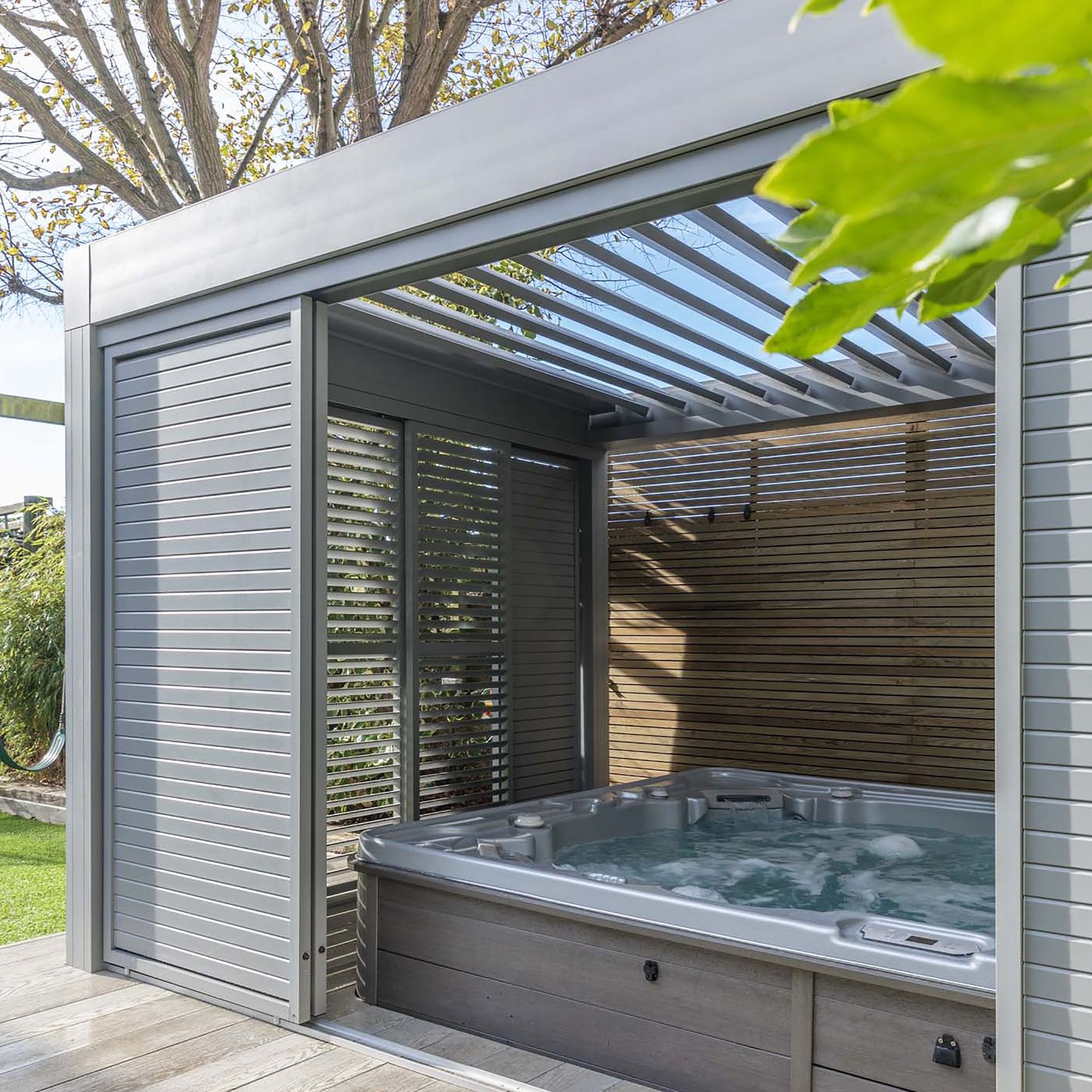 <p>                     An aluminum pergola is a super-sleek way to enclose your hot tub, so you can enjoy it come rain or shine. Sliding side panels come in handy if you want a touch more privacy. It's a perfect addition to a large, modern garden.                   </p>                                      <p>                     Rainwater falling on the watertight roof will add to the experience with a soothing patter. Plus, the roof will make hot tub maintenance easier, too, as will help keep out fallen leaves and other debris.                   </p>