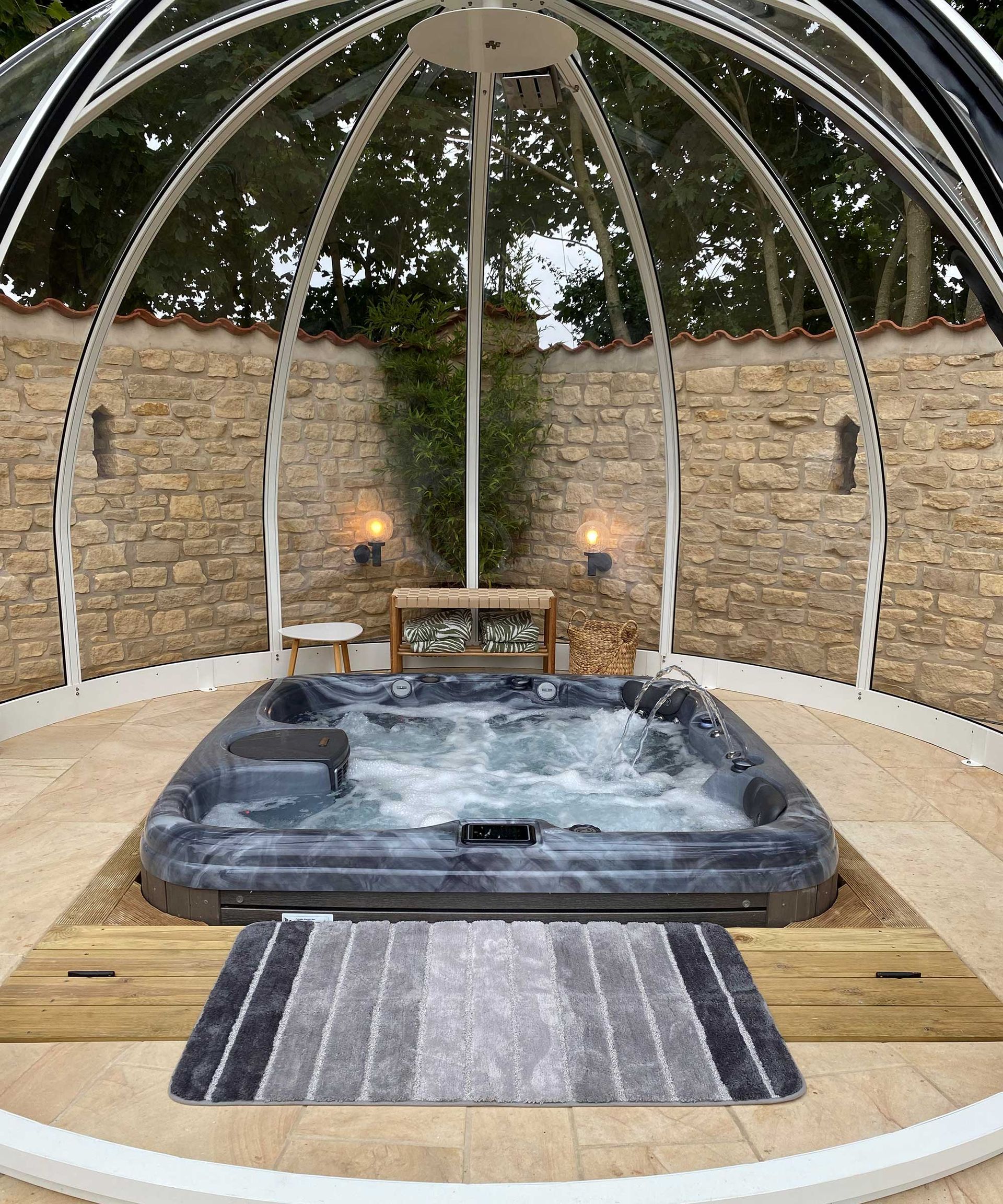 <p>                     Adding a hot tub shelter to your relaxation space is the way forward if you want to use the zone all year-round. From awnings to pergolas, there are plenty of options available. But, if you're looking for something a little different from the norm, a smart structure like this won't disappoint.                   </p>                                      <p>                     The panels of this elegant, domed structure can be slid open and shut, allowing for extra protection from the elements or a dose of fresh air whenever needed, while keeping the space light and bright. It pairs beautifully with the pale stone paving, simple furniture, and a small timber spa-surround.                   </p>