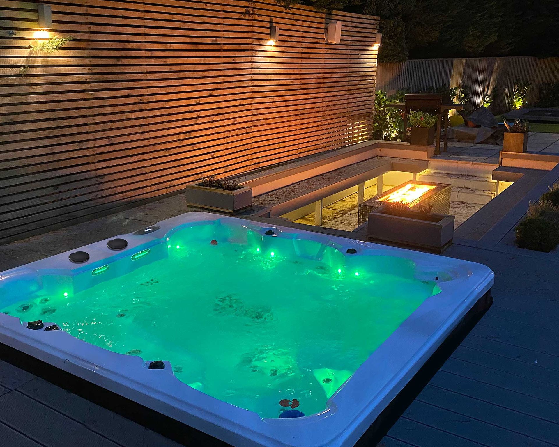 <p>                     Hot tubs aren't just for daytime use if you add in some chic lighting solutions. And we're not just talking about wall lights and festoons to adorn the surrounding space – consider choosing a tub that illuminates, too.                   </p>                                      <p>                     An enticing glow like this will up the ambiance instantly – it's a great addition if you're on the lookout for a garden party. Pair it with a sunken seating space, complete with cozy fire pit, for the ultimate alfresco entertaining zone.                   </p>