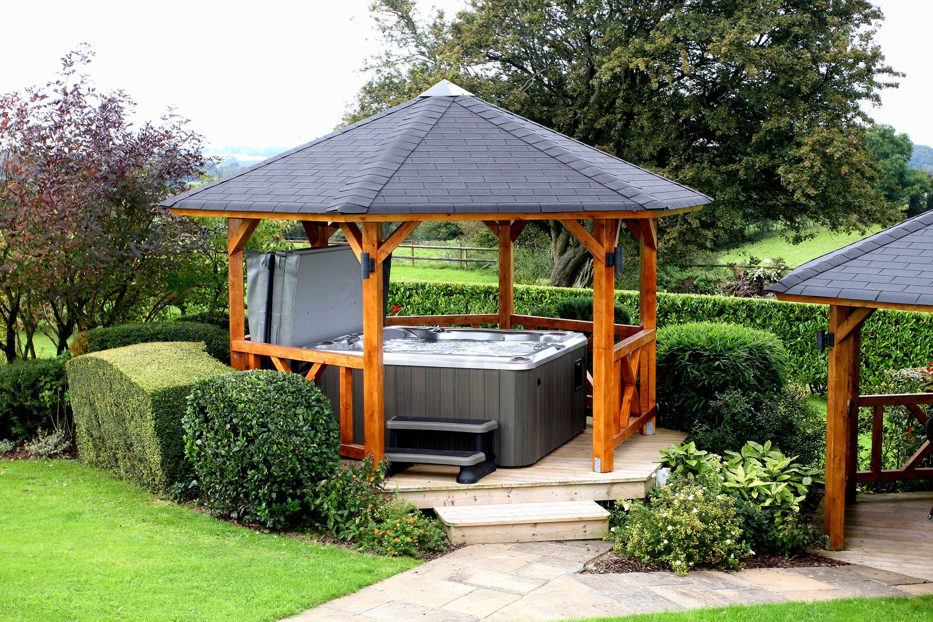 <p>                     A structured hot tub gazebo creates a dedicated outdoor relaxation 'room'. And as well as adding definition to the zone, the roof will keep heavy rain and winds away, keeping it a sheltered sanctuary whatever the weather. Lush green foliage surrounding it will up the zen-appeal, too.                   </p>                                      <p>                     Match the materials to the rest of your garden structures for a cohesive feel.                   </p>