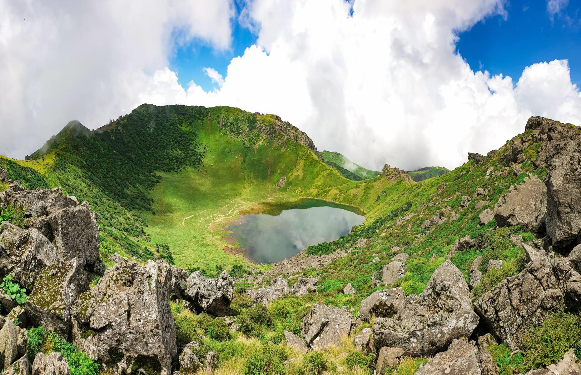 <p>Stunning summits await at Hallasan Mountain, which sits at the center of Jeju Island. Also called Yeongjusan (meaning ‘mountain high enough to pull the galaxy’), this national geopark proudly takes the title of South Korea’s tallest mountain at almost 6,400 feet (1,950m) above sea level. It's home to 1,800 types of plant and 4,000 species of animal, and is topped with a famous crater lake. Immerse yourself in the mountain’s enchanting environment on the Seongpanak (6 miles/9.6km) or Gwaneumsa (5.4 miles/8.7km) trails. The trails are well-maintained, but, as with all mountains, research your route thoroughly before attempting.</p>
