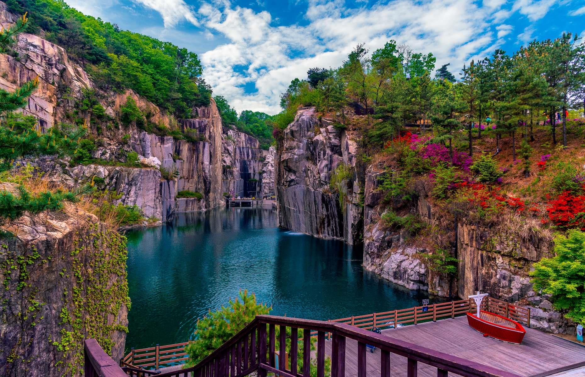 <p>This former rock quarry lay abandoned for decades until the 1990s, when it was finally given a new lease of life as the Pocheon Art Valley. You can still soak up the breathtaking natural beauty of Cheonjoho Lake (pictured) from the observation café and sky park, but it’s now home to an arts and culture complex too. A common date spot, the site boasts an outdoor sculpture park and a performance space nestled under the quarry cliffs, as well as an astronomy museum popular with families with children.</p>