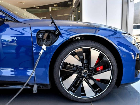 An electric vehicle is connected to a charging point at a Gridserve e-charging station at an Audi Automotive parking lot in Tunis on August 8, 2023.