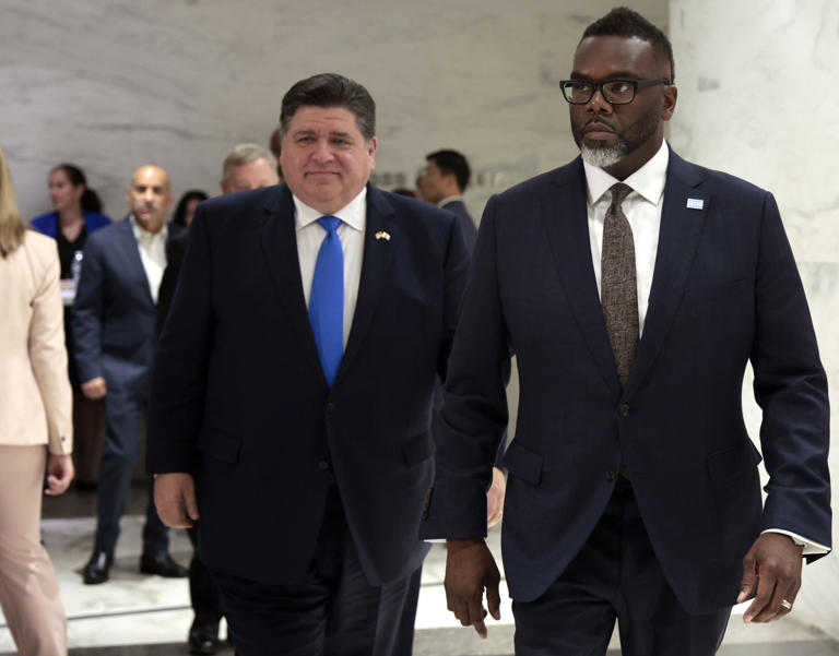 J.B. Pritzker, left, and Chicago Mayor Brandon Johnson arrive for a news conference Aug. 30, 2023, to urge President Joe Biden to use legal authority to expand work authorizations for migrants.