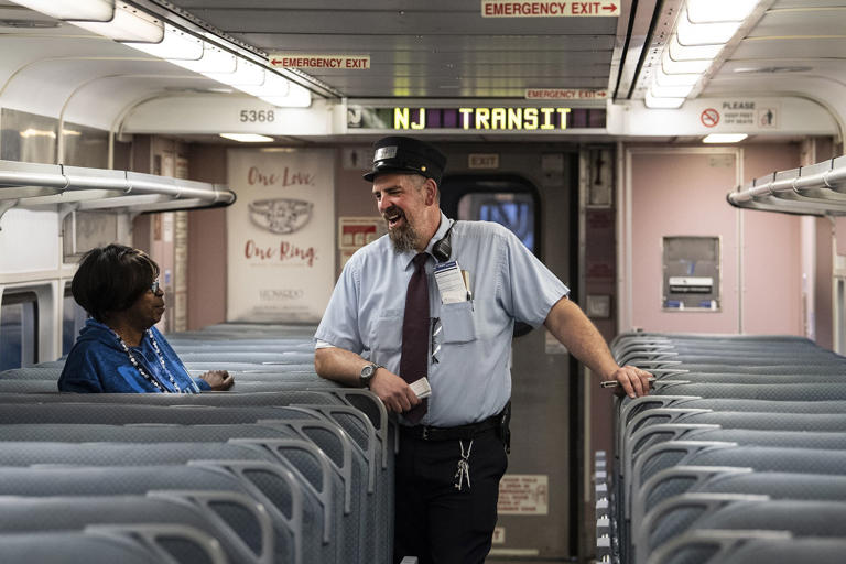 NJ Transit Assistant Train Conductor, Tom Coupe, interacts with passenger, Darnell Barnes, in route to Atlantic City. Sunday, May 2, 2019. New Jersey Transit restored train service to Atlantic City today.