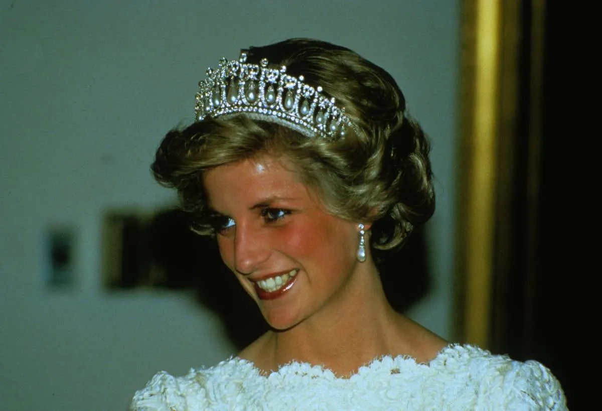 <p>It's hard to upstage a piece of jewelry as stunning as the tiara seen here, but Princess Diana managed to do just that with her beautiful and beaming smile. This photo was taken in November of 1981.</p> <p>Diana and Princess Anne were photographed while en route to the State Opening of Parliament. They're riding in the glass coach that was used in Diana's wedding to Prince Charles just months earlier.</p>