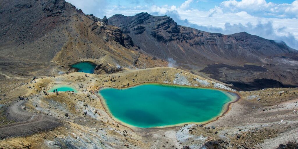<p>Avid hikers won’t want to miss a visit to Tongariro National Park, which is home to the North Island’s best day hike: the Tongariro Alpine Crossing.</p><p>This epic day hike traverses an otherwordly landscape, with technicolor lakes and volcanic peaks being significant highlights.</p><p>Overall, the Tongariro Crossing takes most people between 7-8 hours to complete. It’s a 12-mile (19.4 km) strenuous hike, so it’s a challenging trail—but it’s a highlight for many visitors to the North Island.</p><p>While the Tongariro Crossing is free, hikers need to arrange and pay for a shuttle to transport them to the trailhead and pick them up at the end of the hike. Many shuttle companies in Tongariro National Park offer this service, so you won’t have trouble organizing your hike.</p><p>If the Tongariro Crossing sounds too intimidating, there are plenty of shorter hikes in the area, including Taranaki Falls and Tama Lakes.</p>