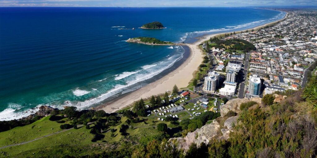 <p>Mount Maunganui is a picturesque coastal town known for its long stretch of golden sandy beach and its namesake volcanic cone: Mount Maunganui, or “the Mount,” as locals often refer to it.</p><p>One of the best things to do here is to <a href="https://weekendpath.com/mount-maunganui-walks/" rel="noreferrer noopener">hike up Mount Maunganui</a>, where you’ll get incredible panoramic views from the summit. If that sounds like too much work, there’s also an easy, relatively flat hiking track that circles the base of Mount Maunganui.</p><p>After hiking the Mount, you can soak in the Mount Maunganui heated saltwater pools at the mountain’s base. There’s no better way to relax after hiking!</p><p>When you’re not busy hiking or relaxing in the hot pools, you can hang out at the beautiful beach or peruse the many local shops and restaurants along Mount Maunganui’s Main Street.</p>