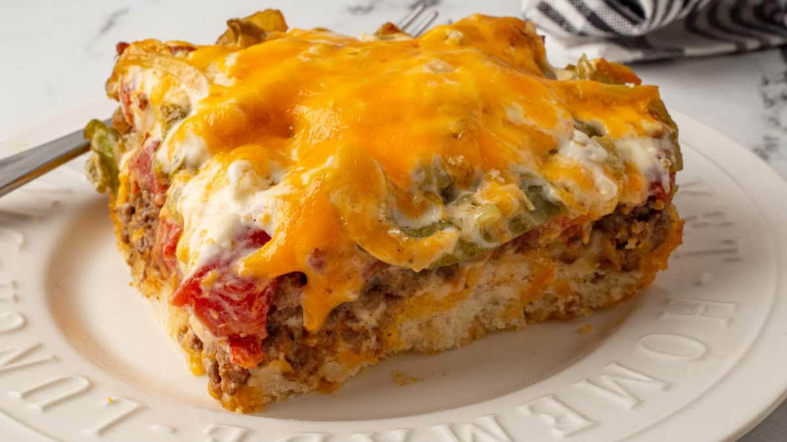 <p>This easy casserole recipe is filled with layers of ground beef with taco seasoning, green peppers, onions, and a sour-cream-based cheesy sauce topped with cheddar cheese. The layers sit on top of a delicious biscuit crust. John Wayne Casserole is a sensational recipe and exactly what you need for a busy weeknight dinner.</p><p><strong>Get the Recipe: <a href="https://shesnotcookin.com/john-wayne-casserole-with-bisquick" rel="noreferrer noopener">John Wayne Casserole</a></strong></p>