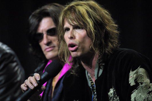 25 Jan 2001: Steve Tyler from the rock band Aerosmith speaks as Joe Perry looks on during the press conference for performers in the Super Bowl halftime show at the Tampa Convention Center in Tampa, Florida. DIGITAL IMAGE. Mandatory Credit: Andy Lyons/ALLSPORT