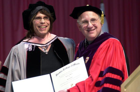 BOSTON - MAY 10: Steven Tyler (L), lead singer for the band Aerosmith, receives an honorary Doctorate of Music degree from President Lee Eliot Berk at the Berklee College of Music commencement ceremony May 10, 2003 in Boston, Massachusetts. Tyler received an Honorary Doctorate of Music at the Baccalaureate Ceremony. (Photo by Douglas McFadd/Getty Images)  
