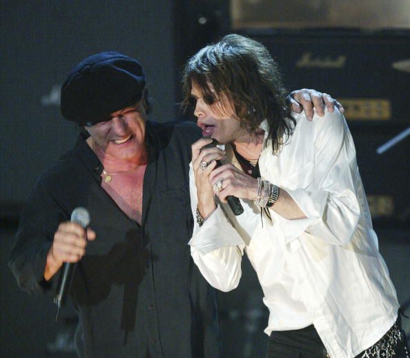 NEW YORK - MARCH 10: Singer Brian Johnson (L) of AC/DC and Aerosmith singer Steven Tyler perform at the18th Rock and Roll Hall of Fame induction ceremony at the Waldorf-Astoria Hotel on March 10, 2003 in New York City. AC/DC was inducted into the Hall of Fame along with The Righteous Brothers, Mo Ostin, The Clash and The Police. (Photo by Frank Micelotta/Getty Images)