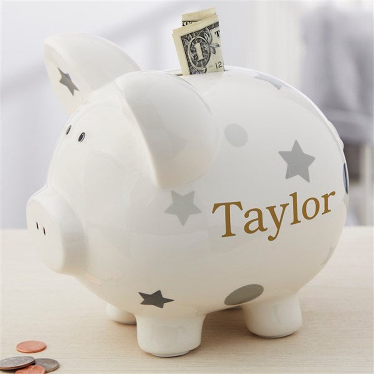 <p>It's never too early to start thinking about a baby's future. This <a href="https://www.personalizationmall.com/Personalized-Piggy-Bank-Grey-Polka-Dot-p22478.prod" rel="noopener noreferrer">ceramic piggy bank</a> comes in three colors and will be a welcome addition to any nursery. Consider adding a few dollars to help get them started. After all, saving money is one of the <a href="https://www.rd.com/list/pay-for-college-without-loans/" rel="noopener noreferrer">best ways to avoid student loans</a>.</p> <p class="listicle-page__cta-button-shop"><a class="shop-btn" href="https://www.personalizationmall.com/Personalized-Piggy-Bank-Grey-Polka-Dot-p22478.prod">Shop Now</a></p>