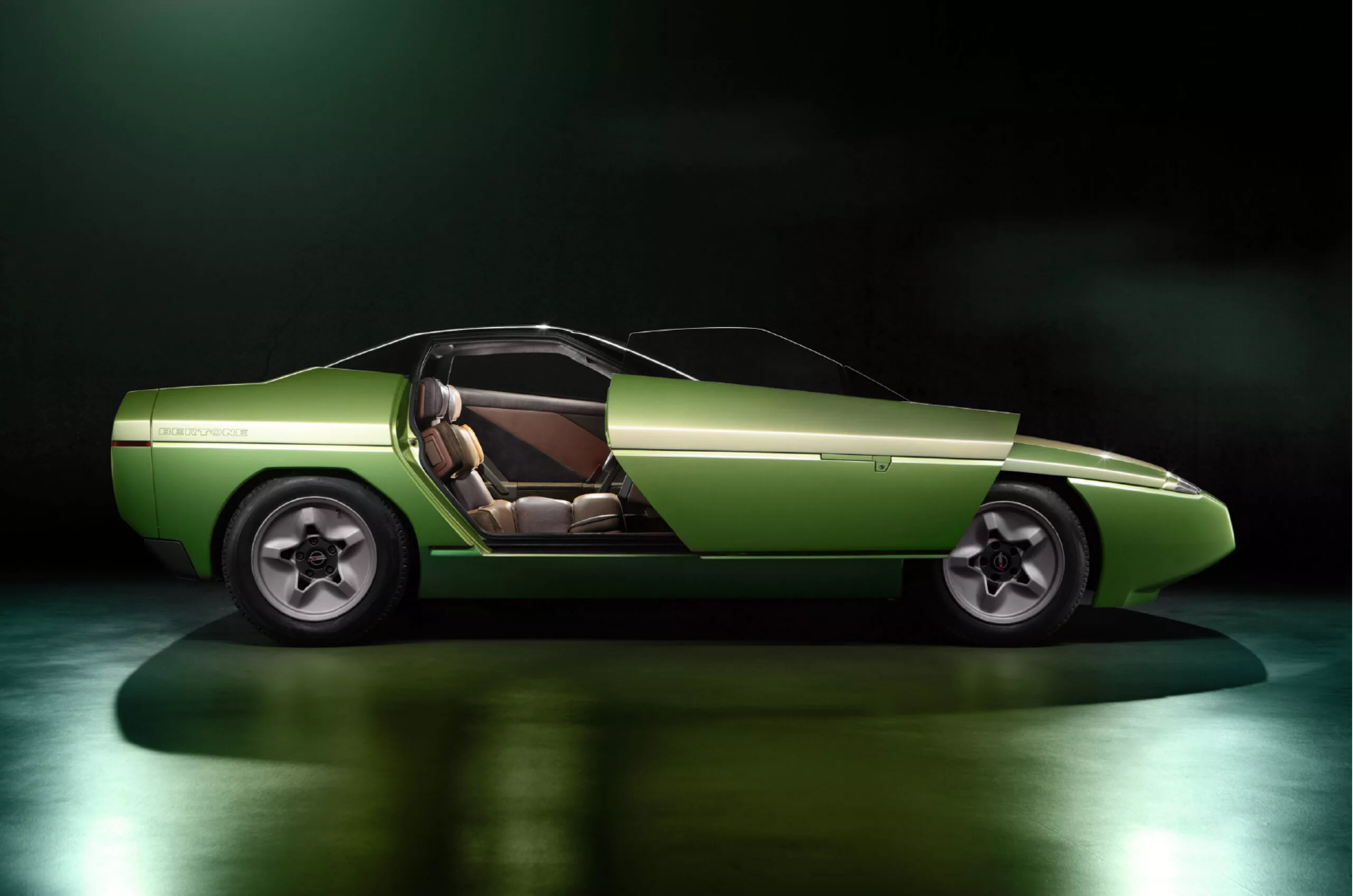<p>Crafted on the chassis of the Chevrolet Corvette, the Bertone Ramarro concept had to distinguish itself from that popular sports car.</p>  <p>Bucking the trend, Bertone opted for doors that swung out and forwards. The overall design was a vehicle that was shorter and wider than the stock Corvette of the time, and the radiator and air conditioning were moved to the rear where the spare tire was usually stored.</p>  <p>After its reveal in Los Angeles before the 1984 Olympics, it went on tour around several motor shows</p>  <p>In 1985 the Ramarro was crowned with the Car Design Award for concept cars. The judges reportedly said: “its bold ideas worked into a design project which gives the Chevrolet Corvette an entirely new personality.”</p>