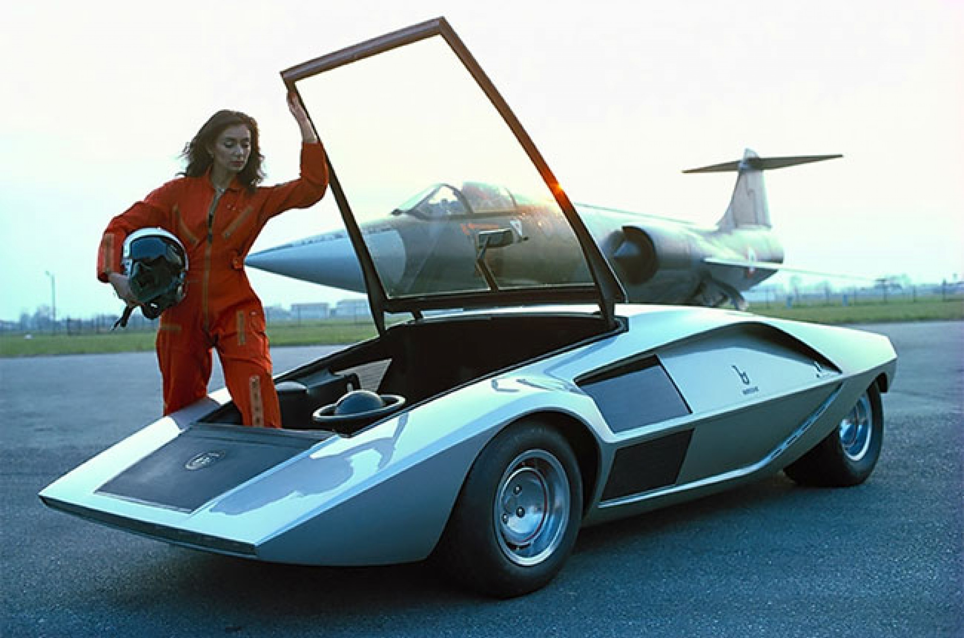<p>Lancia’s Stratos Zero concept is a combination of a door and windshield redesign.</p>  <p>There are classic cars aplenty where the windshield pops out slightly to act as an additional form of ventilation, but usually if it protrudes to this extent, something has gone horribly wrong.</p>  <p>However, the Stratos Zero’s windshield was intended to be utilized as the access point to the two seats. In fact, conventional doors would have been an impossibility for this car.</p>  <p>Clearly not willing to be constrained by traditional automotive construction, Marcello Gandini embraced the wedge shape and built a car around it.</p>  <p>As is true of several of these quirky door designs, they capture moments in time when safety and practicality weren’t necessarily paramount.</p>