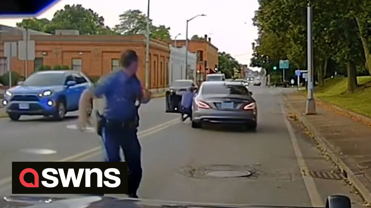 Moment Police Officer Dragged Along Road By Fleeing Driver During Routine Traffic Stop