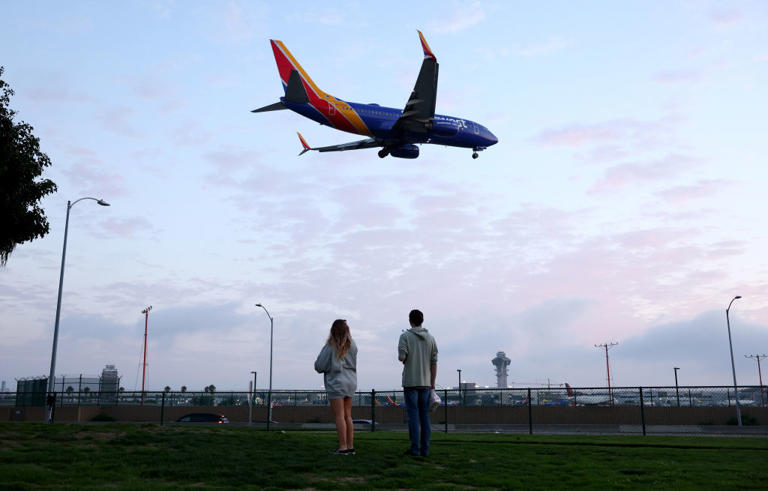 FILE - People view a Southwest Airlines plane landing from a park next to LAX in August 2023 in Los Angeles.