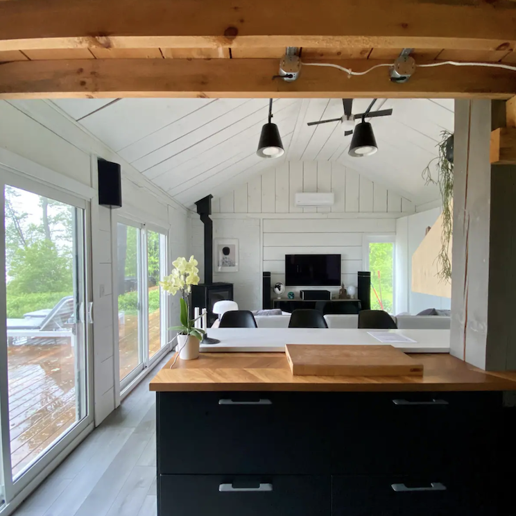 <p>Inside, the newly renovated interior is small but mighty, with an open-concept setup and a loft featuring a king-sized bed. There’s also a washer, a wood-burning fireplace and two sofa beds below if you’re travelling with a family or group.</p>
