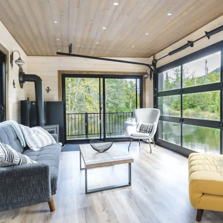 <p>Inside, there’s a modern feel to this retreat with clean lines, dark furniture and smart finishes. Pot lights, a fireplace and a cozy breakfast nook all add to the overall charm, plus there’s a cozy second-storey bedroom with equally breathtaking views.</p>