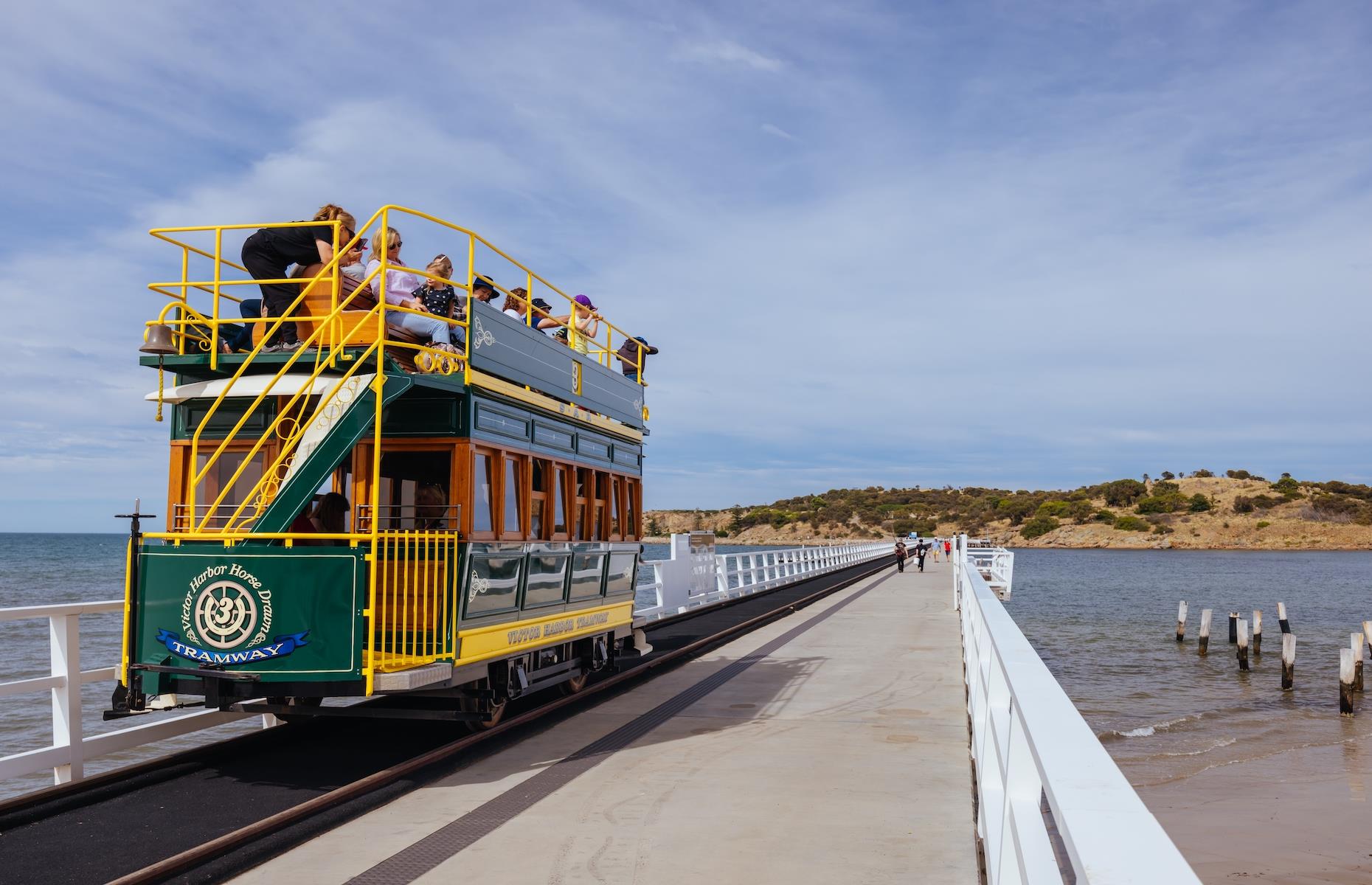 <p>Aside from whale watching, one of the most popular things to do in Victor Harbor is to catch the horse-drawn tram over the causeway to rugged Granite Island. Drawn by Clydesdale horses, the tramway began operating in 1894. An iconic landmark, the old heritage-listed causeway was decommissioned in 2022 due to safety concerns and a new one recently opened. The ends of the old structure are now viewing platforms. Carry on your journey into the past by boarding the heritage <a href="https://www.steamrangerheritagerailway.org/our-trains/cockle-train/">Cockle Train </a>for a steam-rail ride along the high cliffs en route to Port Elliot and Goolwa where more heritage beauty awaits.</p>