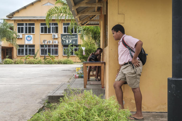 Children play at the entrance of the Au Cap Primary School, on the island of Mahe.