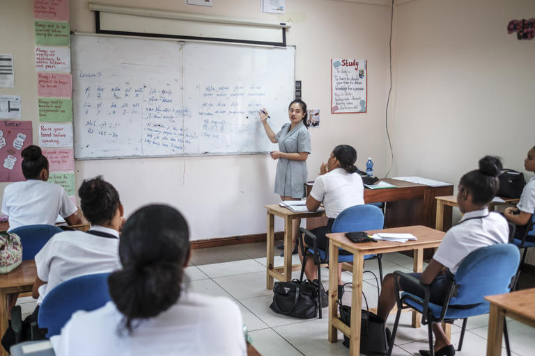 A teacher leads a group of students during a Chinese class at the Seychelles Tourism Academy.