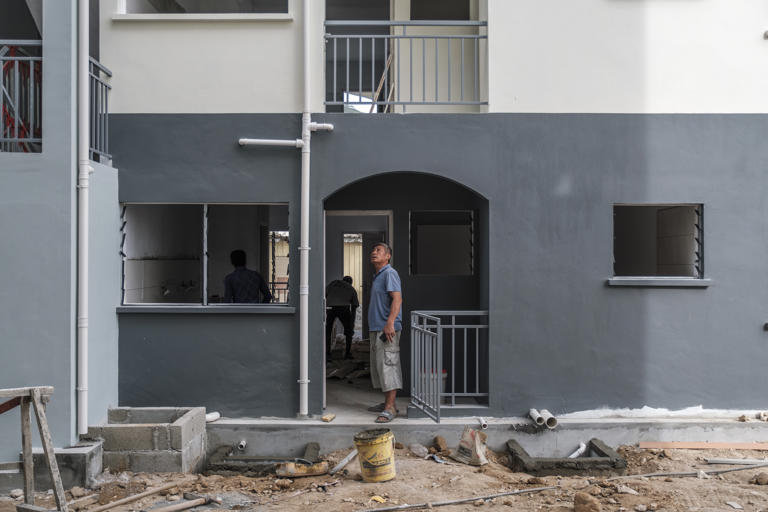 A Chinese supervisor checks out a new building for subsidized housing.