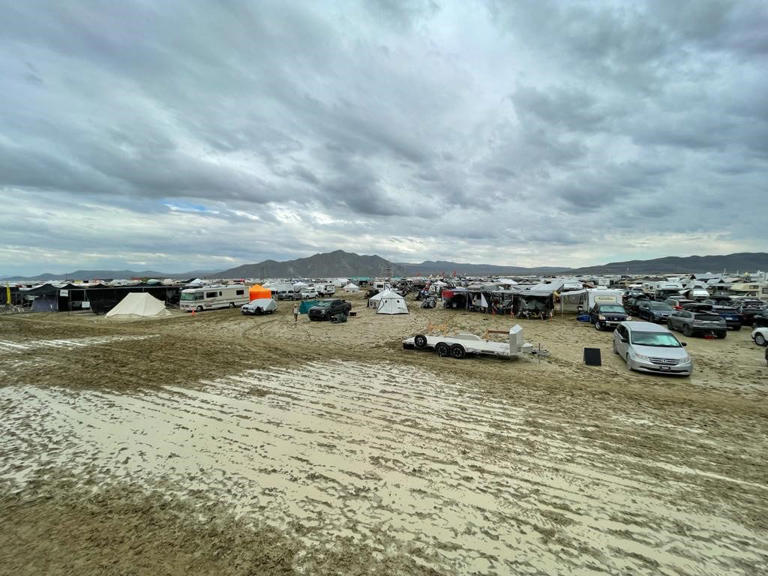 Camps are set on a muddy desert plain on Sept. 2, 2023, after heavy rains turned the annual Burning Man festival site in Nevada's Black Rock Desert into a mud pit. 