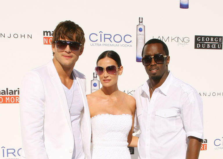 Then-couple Ashton Kutcher and Demi Moore pose with Diddy at the White Party in 2009. (Michael Tran/FilmMagic)