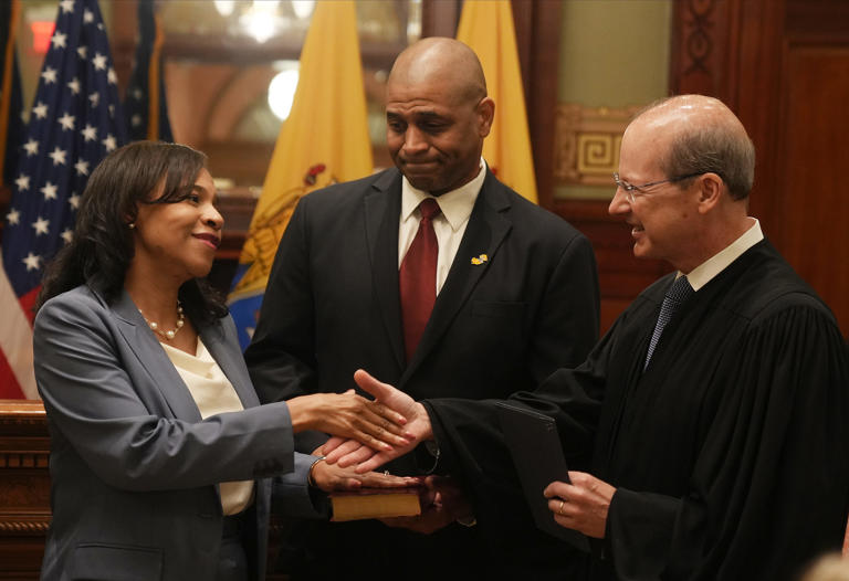 Trenton, NJ September 8, 2023 -- Tahesha Way, with her husband Charles holding the Bible is sworn in as the new Lt. Governor by NJ Chief Justice Stuart Rabner. Tahesha Way was sworn in as the new New Jersey Lt. Governor, replacing the late Sheila Oliver. The ceremony took place outside Governor Phil Murphy's office in the NJ Statehouse on September 8, 2023.
