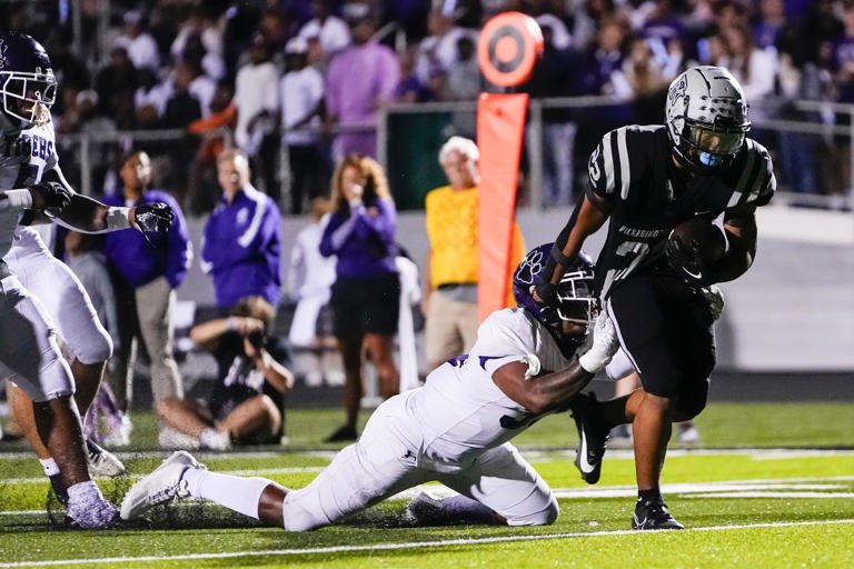 Pickerington North running back Michael Taylor drags Pickerington Central linebacker Braylen Landrum into the end zone for a touchdown during North's 39-34 home win last season.